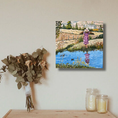 Woman at pond in country.  Farmhouse in background. Ducks in water. Reflections. Paddocks of dry meadow.