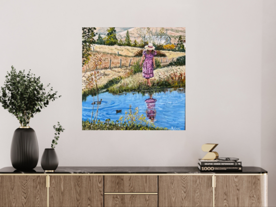 Woman at pond in country.  Farmhouse in background. Ducks in water. Reflections. Paddocks of dry meadow.