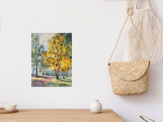 Tree with yellow leaves in a forest with a path