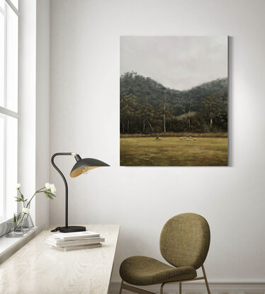 Flock of sheep in the foreground of a dramatic Australian landscape dense with gum trees.