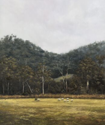 Flock of sheep in the foreground of a dramatic Australian landscape dense with gum trees.