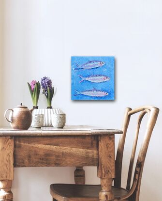 A painting of three silver sardines swimming through a textured blue sea, 