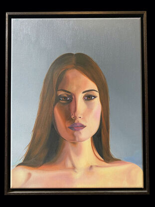 A framed oil on canvas portrait of a woman. The painting features a serene woman with long brown hair and a contemplative expression, set against a soft, muted background