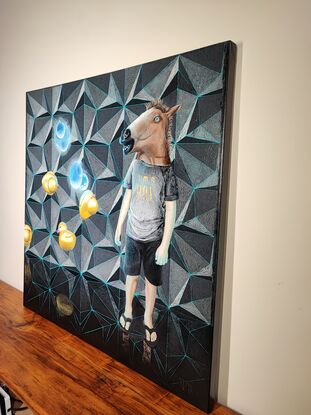 A boy in a horse mask stands in front of a wall featuring a geometric pattern. Six rubber ducks are levitating near him, two of them glowing neon blue. The boy wears a t-shirt with the print 'I'm a Boy.'