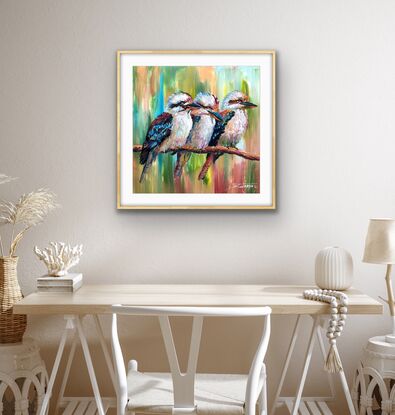 Three kookaburras sitting on a branch, painted in a colourful style.