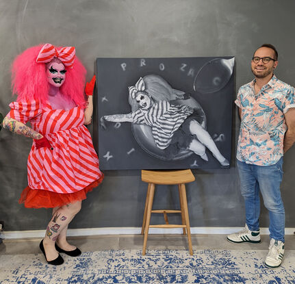 The painting features drag performer, Prozac lying in a circular inflatable pool ring, seemingly drifting in a pool. Prozac is dressed in a playful, striped outfit with a large bow on their head. Their makeup is exaggerated and expressive, highlighting their eyes and lips. Tattoos adorn Prozac's arms and legs, adding intricate details to their appearance.

Surrounding Prozac, the letters "P-R-O-Z-A-C" float in the background, subtly integrated into the scene. These letters have the appearance of alphabet soup. A large spoon hovers in the upper right corner, adding a surreal touch to the composition. The entire painting is rendered in a monochrome palette, emphasizing the contrast between light and shadow. The performer's relaxed pose, combined with the playful and surreal elements, creates a whimsical and dreamlike atmosphere.