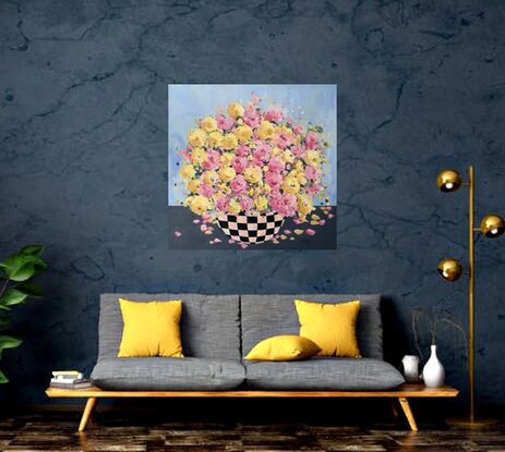 Bright Pink Yellow  flowers bursting in full bloom in a black checkered bowl or vase