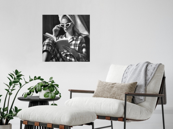 High contrast detailed charcoal  portrait of a beautiful 1950s woman in pyjamas and sunglasses reading a book