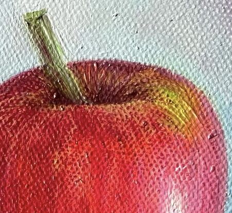 A small painting of a red apple with a blue background on a framed canvas.