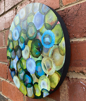 Round Art. Abstract painting with dots and organic forms reminiscent of science, the sea or underwater. Colourful with many layers of colour and floating forms. Green, emerald, blue, aqua , lemon, black and white. A unique mixing of original abstract art with microbiology and science. Cellular art. Jelly fish forms. Calming and peaceful. 