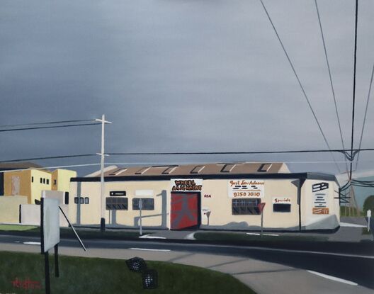 a suburban auto repair shop depicted with some ominous clouds moving in.