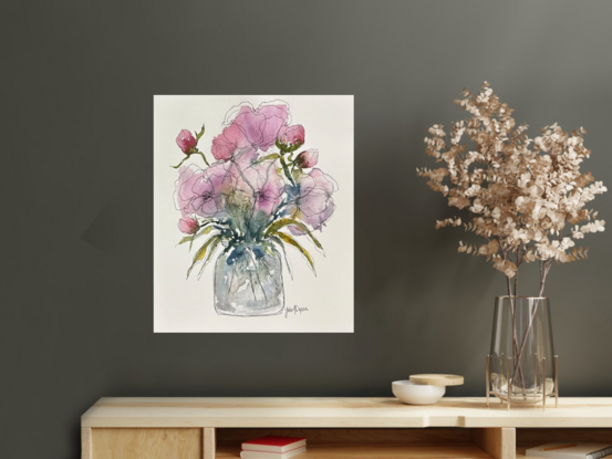 A bouquet of soft pastel roses and buds in pink and mauve in a glass vase