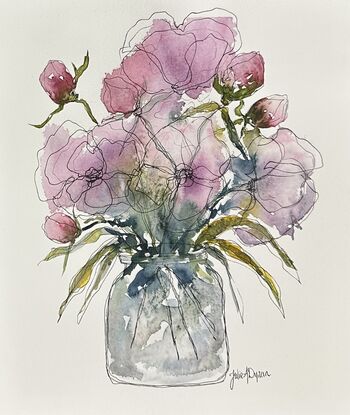 A bouquet of soft pastel roses and buds in pink and mauve in a glass vase