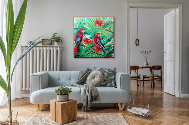 his painting depicts two vibrant rosella parrots perched among lush green foliage and bright red flowers. The birds, predominantly red with blue accents on their wings and tails, are positioned in a lively tropical setting.