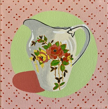 Small china jug  with floral pattern set on a green and pink background 