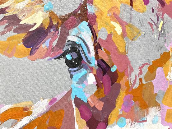 Portrait of a cow on a neutral gray background with pops of colour in the face of the cow. 