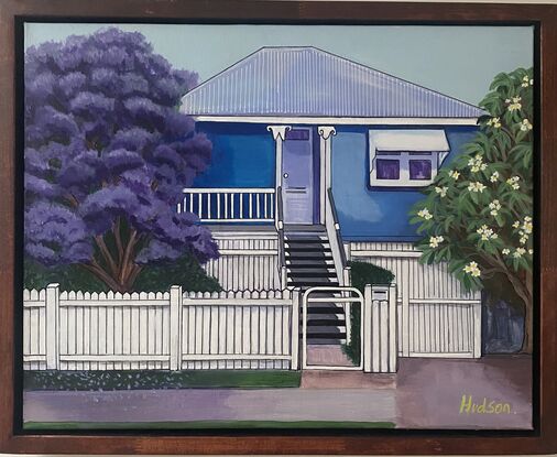 Typical blue Queenslander style home found in Brisbane. It is surrounded by. frangipani tree and a Jacaranda tree common in Brisbane. All neatly behind a white picket fence. 