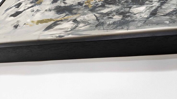 a large abstract landscape in shades of black, grey and white inspired by trees, branches and light. there is metallic gold leaf.