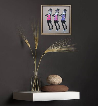 Three black cats in top hats and glittering costumes doing a vaudeville dance