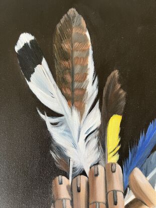 Feathers in a wood artist's hand. 