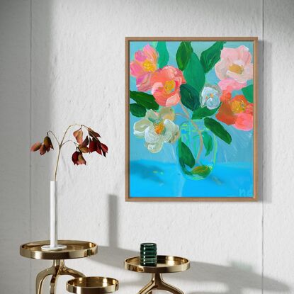 Pink red white camellias in glass vase with blue background. Relaxing and peaceful scene 