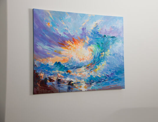 This is a vibrant painting depicting a dynamic and colorful seascape. The artwork features a swirling wave crashing against the shore, with splashes of water highlighted in shades of blue, green, and turquoise. The sky above is a mix of warm and cool colors, including hues of purple, orange, and pink. The brushstrokes are expressive and energetic, capturing the movement and power of the ocean. In the foreground, there are rocks partially submerged in water, adding depth and texture to the scene. The overall composition conveys a sense of movement, energy, and the beauty of nature.