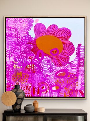 Squiggly pink shapes on a background of white, pink, red and Sienna allowing a large flower to occupy centre stage 