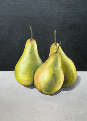 Three green pears on a bench top 