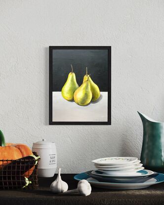 Three green pears on a bench top 