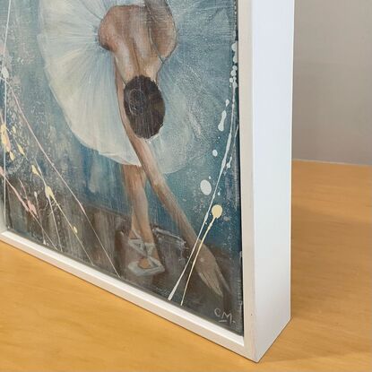 Featuring a beautiful Prima Dona ballerina taking a bow at the close of her magnificent performance, this original artwork by Carmel McCarney features expressive brush strokes and layers of texture.  Softness of the tutu compliments the beautiful elegant features of the ballerina. Gentle blue palette framed in a white wooden frame makes this piece perfect for a child’s room or playroom or a living area or bedroom of anyone who appreciates the elegance of the arts and ballet. This would pair well with En Pointe, also by Carmel McCarney