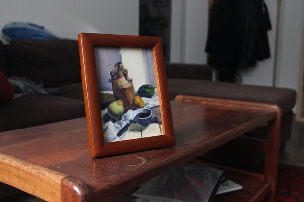 Original oil painting of ceramics and fruit on table.