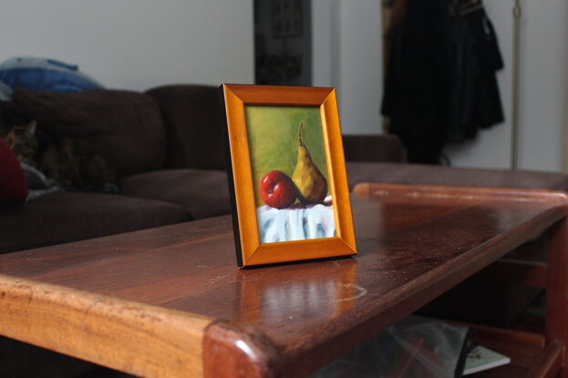 Red apple and yellow pear on table.