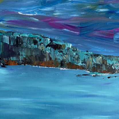 Rich turquoise, blues  and teals with flashes of gold and magenta form an almost mystical  look across the bay. The texture on the rocks with hints of teal  on a bold background of indigo and brown sets the stage forming depth and structure  framing the calm waters of the lake.