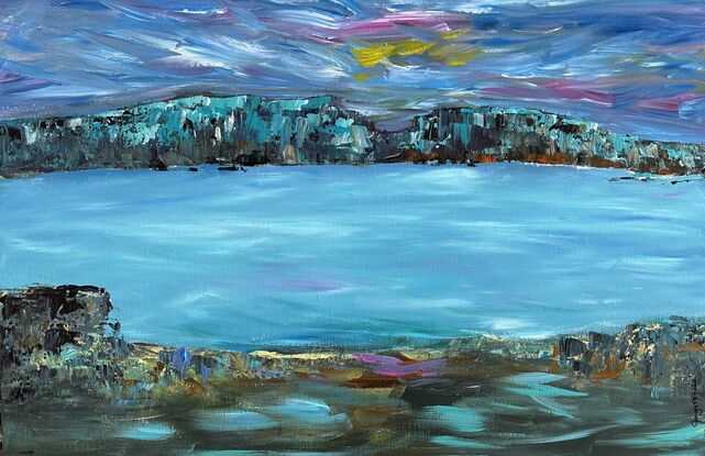 Rich turquoise, blues  and teals with flashes of gold and magenta form an almost mystical  look across the bay. The texture on the rocks with hints of teal  on a bold background of indigo and brown sets the stage forming depth and structure  framing the calm waters of the lake.