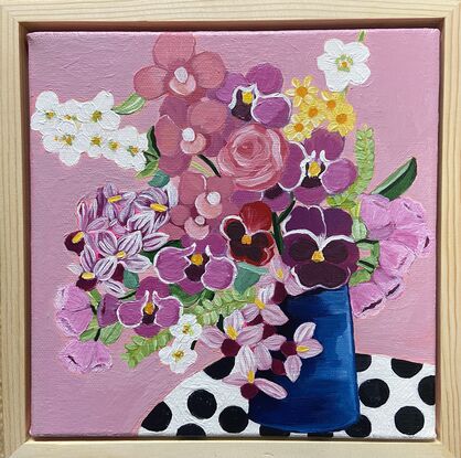 Small painting with flowers in blue vase on polka dot tablecloth 