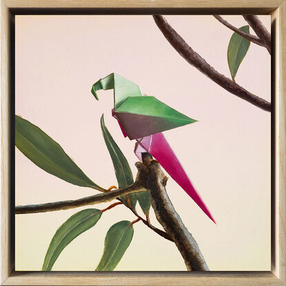 A purple and pink origami parrot perched on a bare branch with purple flowers growing. 