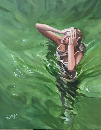 Three quarter aerial view of a woman standing chest deep in deep green water