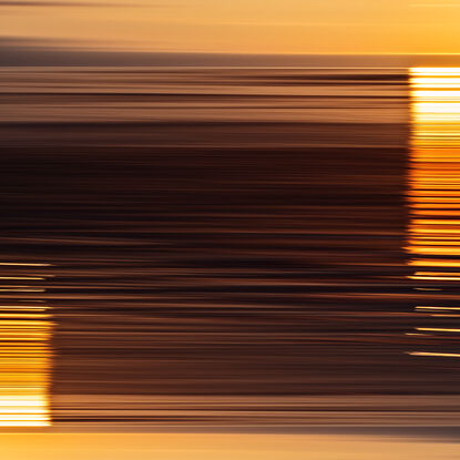 yellow, orange and red parallel lines referencing light reflecting off the ocean