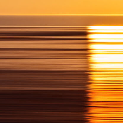 yellow, orange and red parallel lines referencing light reflecting off the ocean