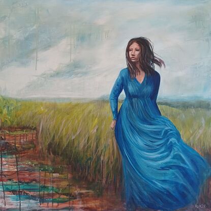 Woman in blue dress walking in open plain near wetlands