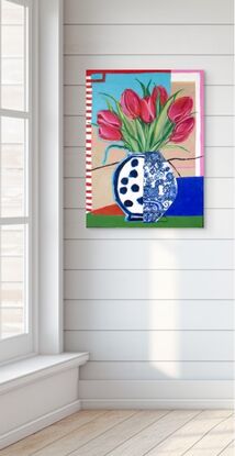 Red tulips in a blue and white mixed design vase