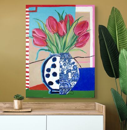 Red tulips in a blue and white mixed design vase