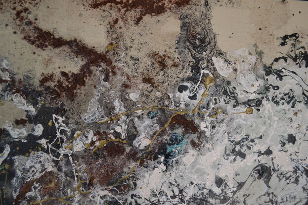 swirling movement of turquoise,  gold, earth tones in abstract forms from above.