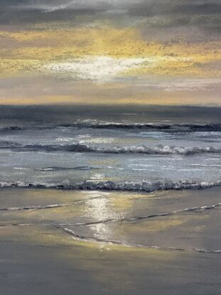 Grey and blue warm glow from the sun setting in the beach 