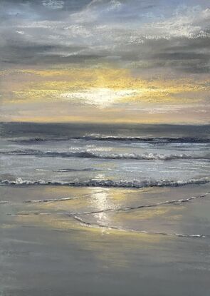 Grey and blue warm glow from the sun setting in the beach 