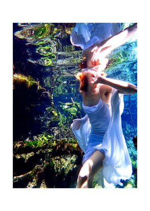 A vibrant underwater scene featuring a girl in a flowing white dress.