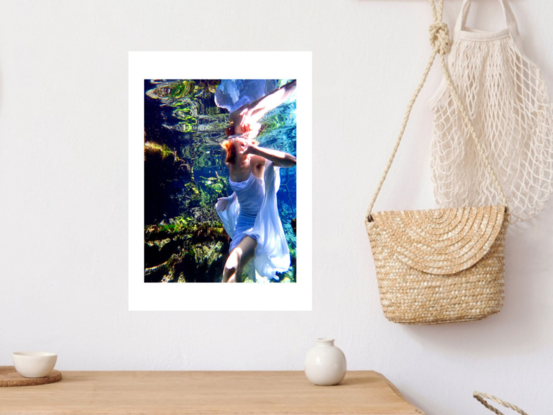 A vibrant underwater scene featuring a girl in a flowing white dress.