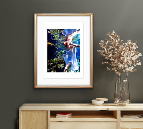 A vibrant underwater scene featuring a girl in a flowing white dress.