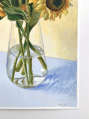 Large sunflower bouquet in glass vase