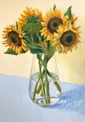 Large sunflower bouquet in glass vase